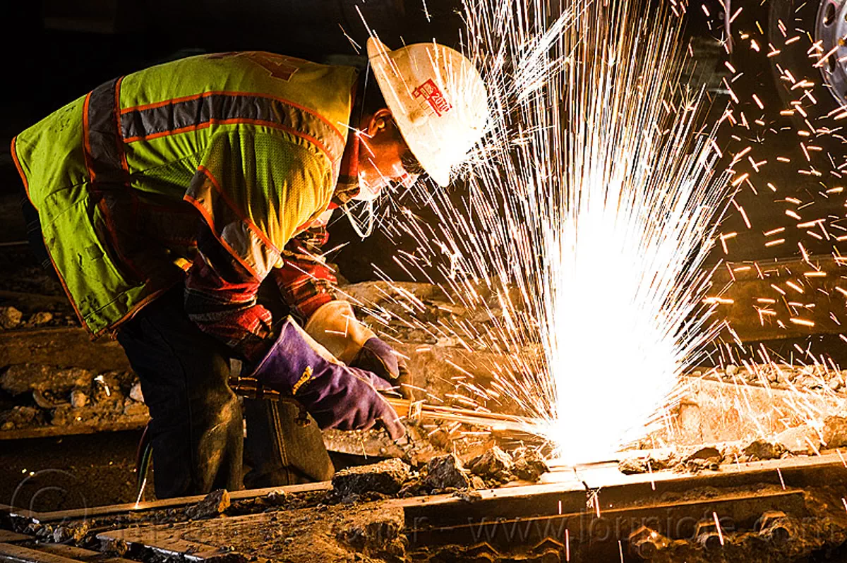oxy-acetylene cutting torch, light rail, man, muni, night, ntk, oxy-fuel cutting, railroad construction, railroad tracks, rails, reflective vest, safety glasses, safety gloves, safety helmet, safety vest, san francisco municipal railway, sparks, track maintenance, track work, welder, worker, stock photo