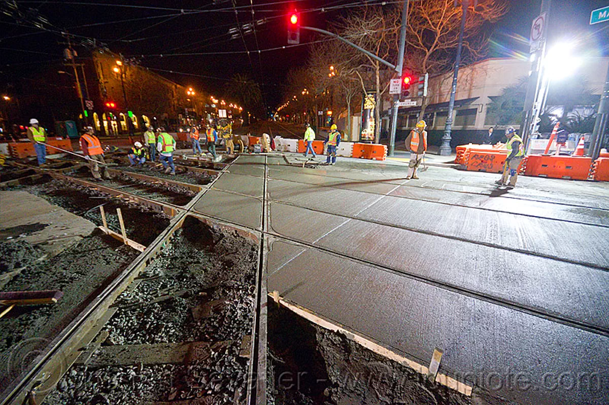 concrete between the rails, cement, light rail, men, muni, night, ntk, railroad construction, railroad tracks, reflective vest, safery vest, safety helmet, san francisco municipal railway, track maintenance, track work, workers