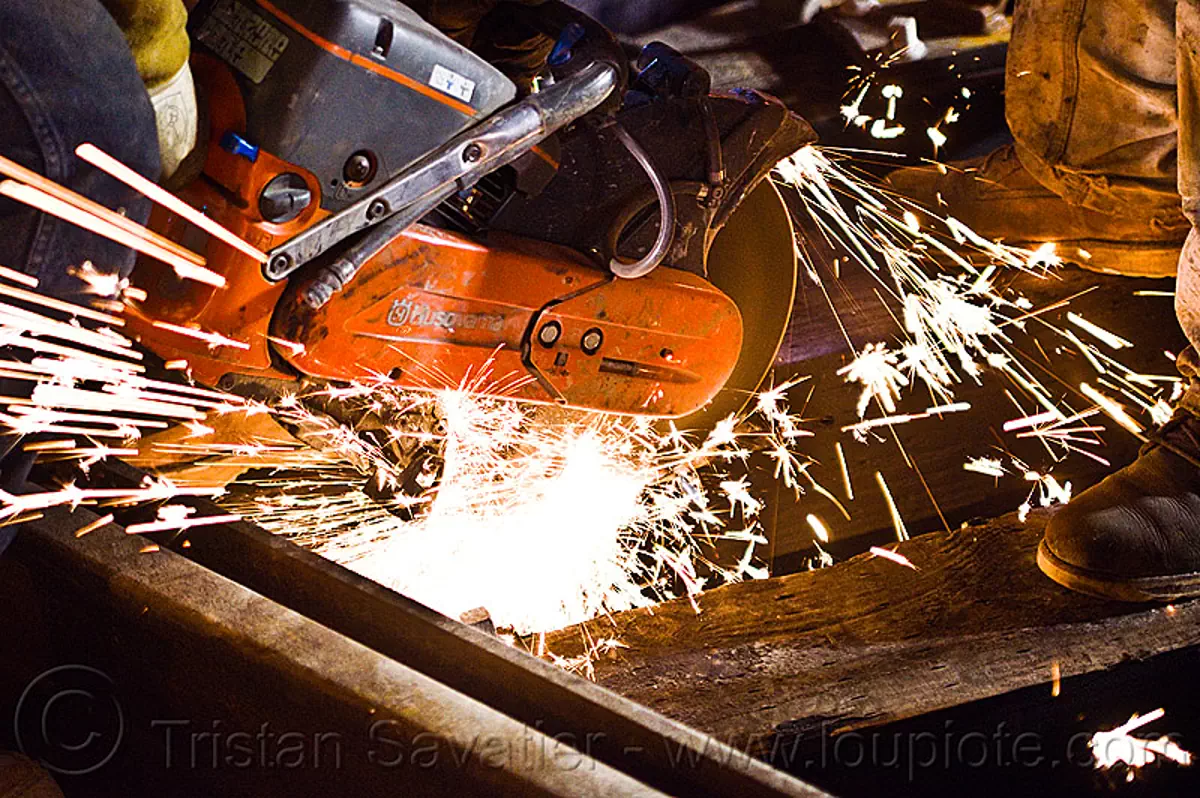 handheld abrasive saw, cut-off saw, cutting, huskvama, k760, light rail, man, muni, night, ntk, power tool, railroad construction, railroad tracks, rails, san francisco municipal railway, sparks, track maintenance, track work, worker, stock photo