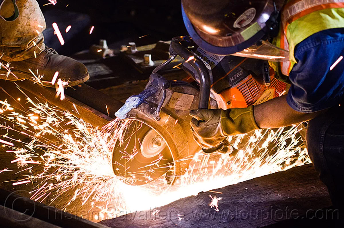 handheld cut-off saw, abrasive saw, cutting, huskvama, k760, light rail, man, muni, night, ntk, power tool, railroad construction, railroad tracks, rails, reflective vest, safery vest, safety helmet, san francisco municipal railway, sparks, track maintenance, track work, worker