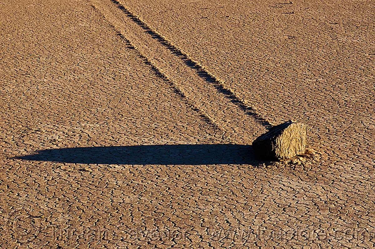 sailing stone on the racetrack (death valley), cracked mud, desert, dry lake, dry mud, moving rock, racetrack playa, sliding rock, track, stock photo