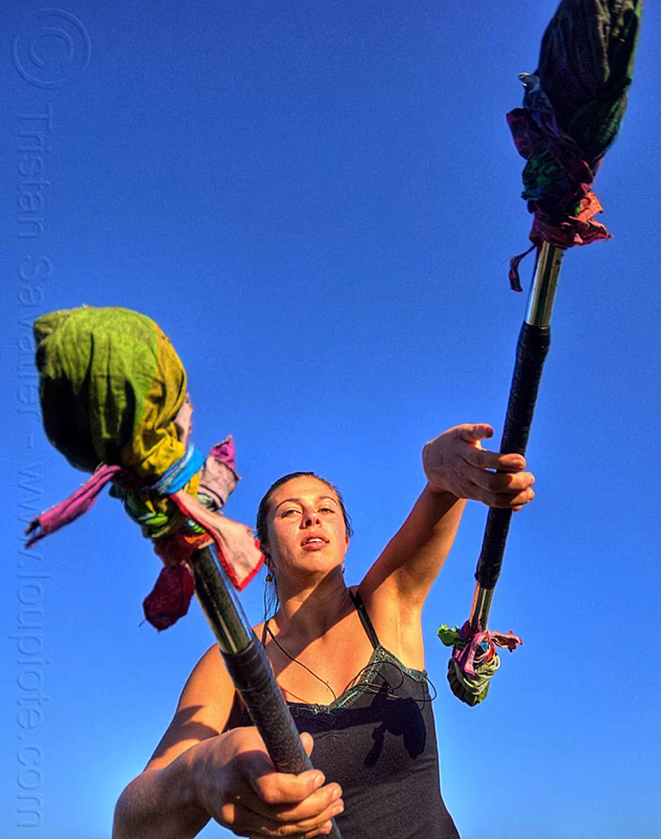 savanna spinning double staff, blue sky, dolores park, staffs, staves, stock photo