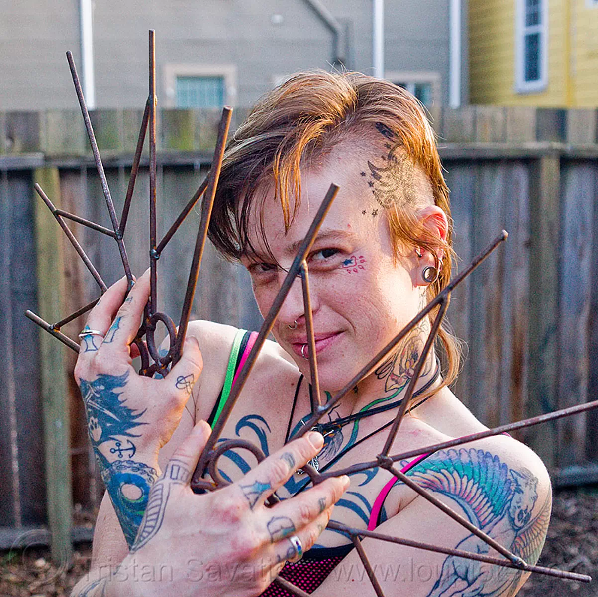 practicing fire fans, leah, spinning fans, tattooed, tattoos