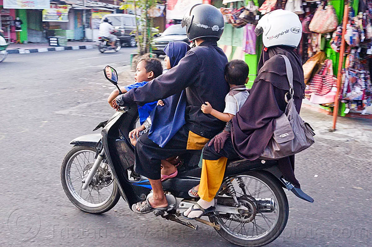 five on a motorbike (indonesia), children, helmets, java, jogja, jogjakarta, kids, man, motorcycle helmet, riding, street, yogyakarta, stock photo