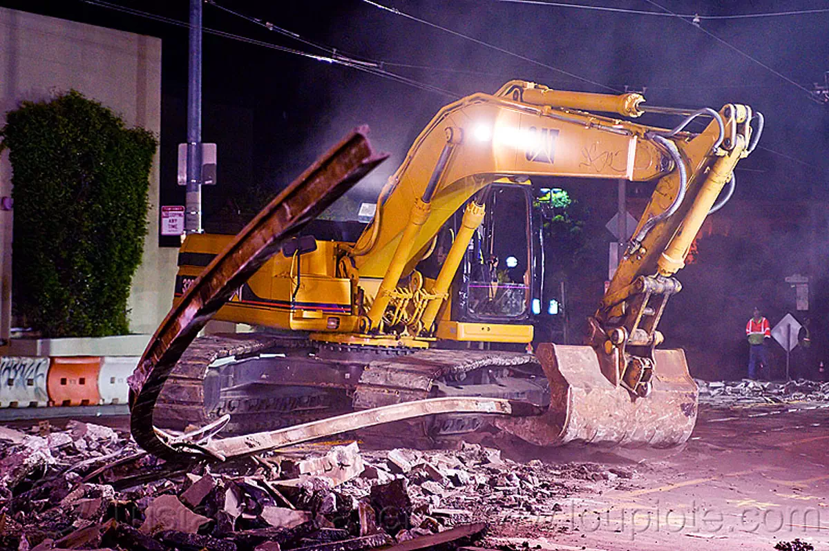 demolition of muni tracks at church and duboce (san francisco), caterpillar, excavator, light rail, machinery, night, ntk, railroad construction, railroad tracks, rails, san francisco municipal railway, track maintenance, track work, stock photo
