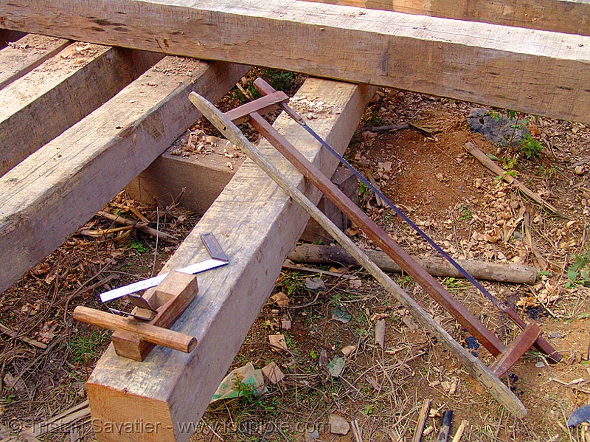 building a house - wood beams and tools - vietnam, construction, hand saw, home builders, lumber, timber, wood saw, stock photo