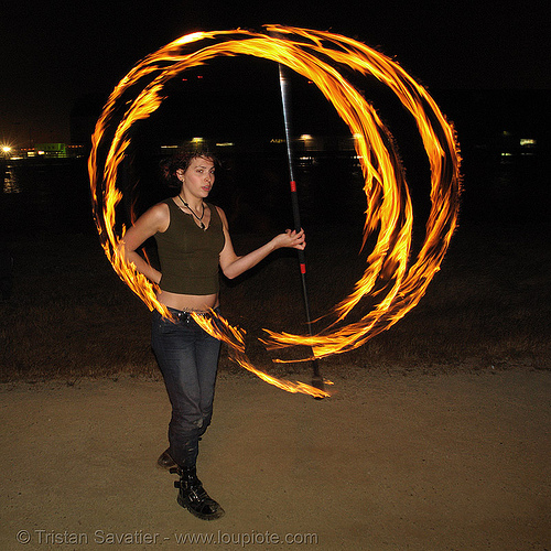 roxy spinning a fire staff