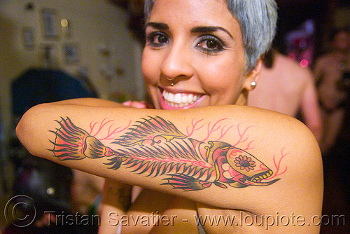 This unique tattoo is a fish represented in the style of the "dia de los 