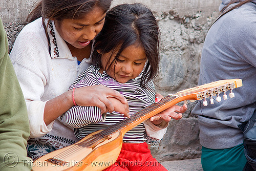 little girls playing with a charango Argentina child instrument Iruya 