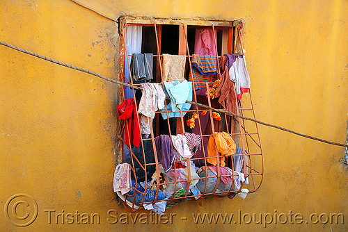 wet clothes hanging at window drying grid Kurdistan Mardin Turkey