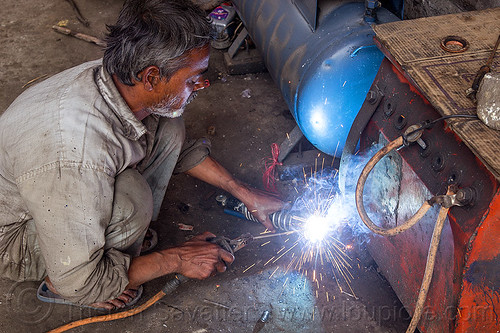 arc welding repair on motorbike shock (india), 350cc, arc welding, fixing, man, mechanic, motorcycle, repairing, royal enfield bullet, shock absorber, sikkim, sparks, thunderbird, welder, worker, working