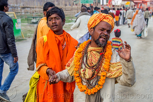 blind man singing and begging, beggar, begging, bhagwa, blind man, flower necklace, headwear, hindu pilgrimage, hinduism, holy beads, kumbh mela, marigold flowers, men, necklaces, saffron color, singing