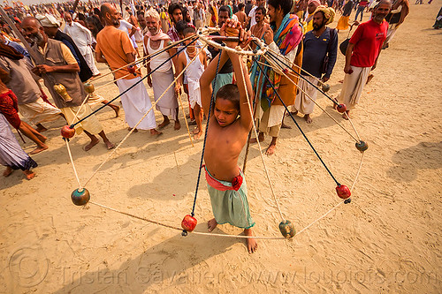 boy spinning colored balls with ropes (india), boy, crowd, game, hindu pilgrimage, hinduism, indian spinning balls, kumbh mela, metal balls, performer, ropes, spectators