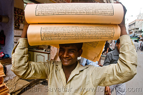 boy with load of printed paper (india), delhi, jayyed press, man, print shop, printed paper, printed sheets, printing shop, tibetan prayers, worker, working