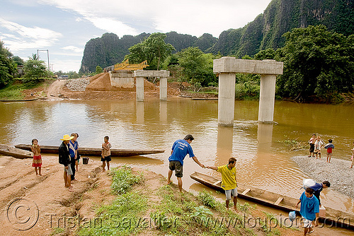 bridge not finished - use canoes to cross river (laos), bridge construction, bridge piers, bridge pillars, ferry boats, kong lor, river crossing