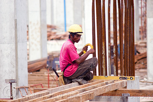 building timber shoring, borneo, bubble level, building construction, concrete forms, concrete wall forms, construction site, construction workers, formwork, lumber, malaysia, man, miri, nylon wire, rebars, safety helmet, scaffolding, shoring, sitting, spirit level, timber