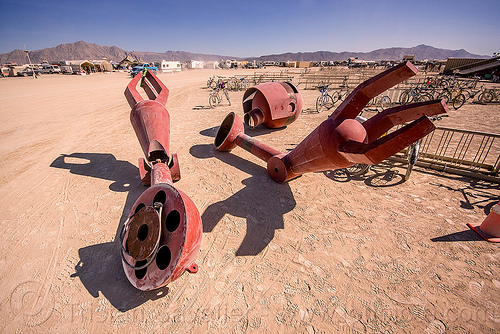 burning man - big red robot dismembered - becoming human, art installation, becoming human, christian ristow, disassembled, dismembered, head, parts, red, robot, sculpture, statue, steel