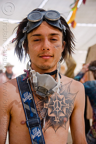 burning man - burner with chest tattoo at center camp cafe, chest tattoo, flower tattoo, goggles, man, peace sign tattoo, tattooed, tattoos, trent