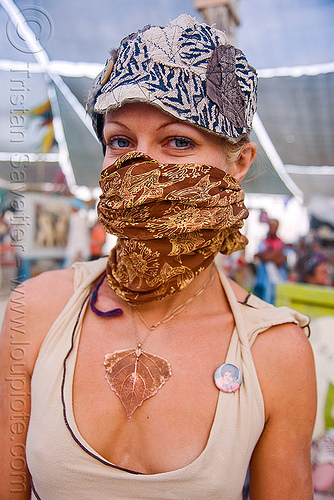 burning man - woman with bandana at the center camp cafe, attire, burning man outfit, cap, hat, leaf necklace, woman, yellow bandana