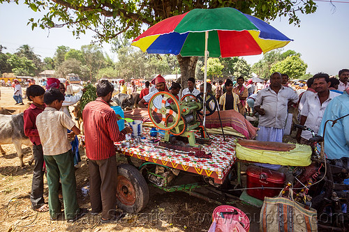 cane juice machine (india), cane juice, crowd, men, press, rainbow colors, stand, street food, street seller, street vendor, sugar cane, trike, umbrella, west bengal