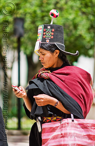 cellphone used by tribe - (bolivia), bolivia, cellphone, hat, indigenous, pom-poms, pom-pons, quechua, tarabuco, woman