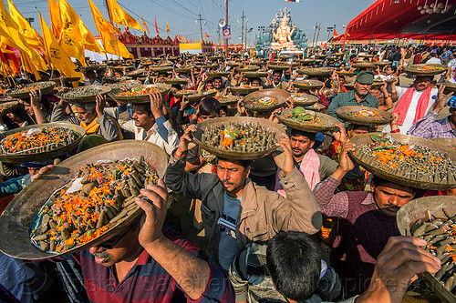 clay shiva lingam's hindu offerings - kumbh mela (india), carrying on the head, clay, crowd, hindu ceremony, hindu pilgrimage, hinduism, kumbh mela, lingams, offerings, shiva linga, shiva lingam, shivling, trays, walking, yellow flags