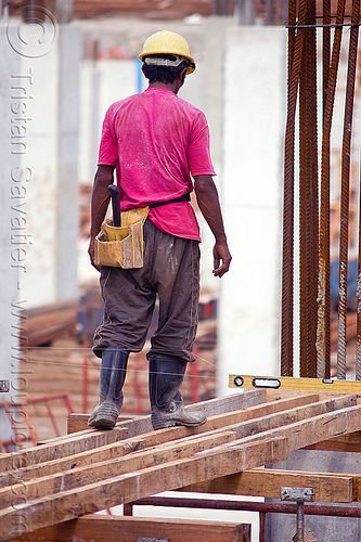 construction worker - timber shoring, borneo, bubble level, building construction, concrete forms, concrete wall forms, construction site, construction workers, formwork, lumber, malaysia, man, miri, rebars, safety helmet, scaffolding, shoring, spirit level, timber, walking