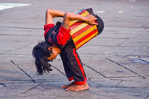 contortionist in barrel - street artist (jakarta), contortionist, eid ul-fitr, fatahillah square, jakarta, man, street performer, taman fatahillah