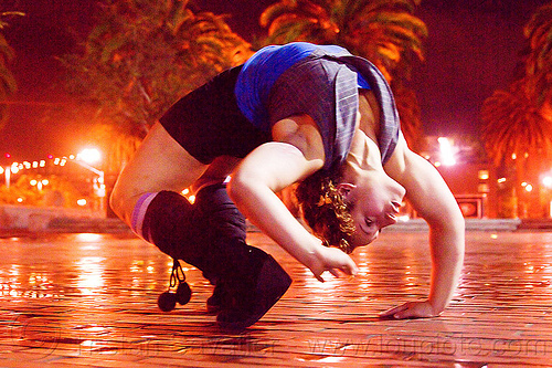 contortionist leaning backward - street artist (san francisco), back stretching, brick floor, brick tiles, contortionist, night, stretch, woman