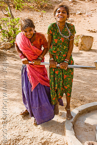 country girls pumping water with hand pump, girls, hand pump, handle, saris, udaipur, water pump