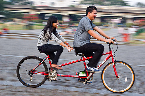 couple on tandem, family, jakarta, man, medan merdeka, merdeka square, moving, park, riding, road, tandem bicycle, tandem bike, woman