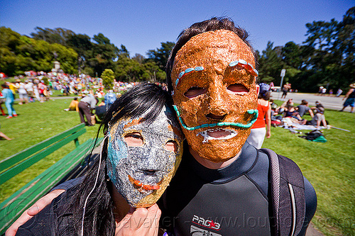 couple with silver and copper color masks, bay to breakers, footrace, golden gate park, green moustache, green mustache, lawn, man, masks, street party, woman