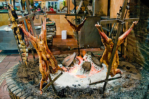 crucified lamb barbecue roasting in restaurant (buenos aires), argentina, asado, barbecue, bbq, buenos aires, carcass, cooked meat, cooking, crucified lamb, la estancia, lambs, restaurant, roasting, wood fire