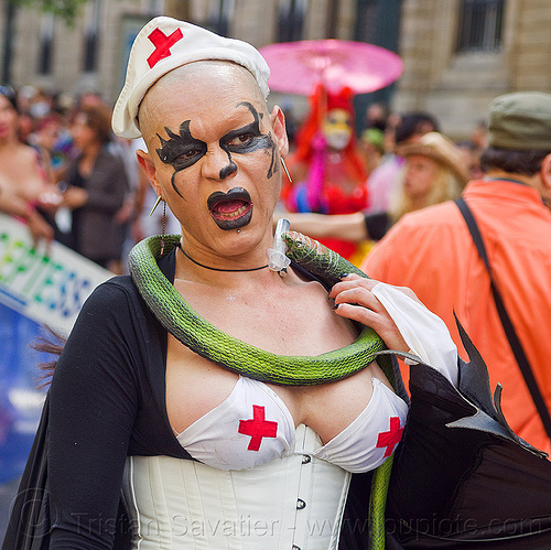 decadent nurse costume, corset, costume, gay pride, hat, makeup, necklace, nurse uniform, seringe, snake, woman