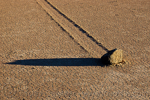 detail of sailing stone and its track on the racetrack - death valley, closeup, cracked mud, death valley, dry lake, dry mud, racetrack playa, rock, sailing stones, sliding rocks