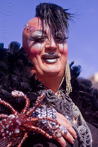 drag queen with black feathers - vivian, bindis, black feathers, drag queen, earrings, man, mohawk hair, necklace, vivian