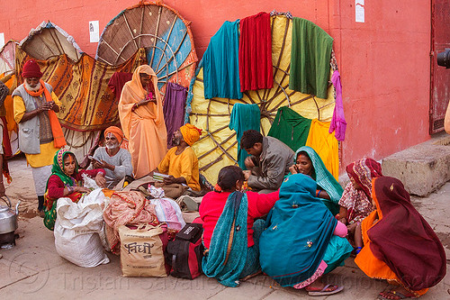 family of hindu pilgrims on the ghats of varanasi (india), colorful, family, ghats, hindu, hinduism, indian women, men, sitting, squatting, varanasi