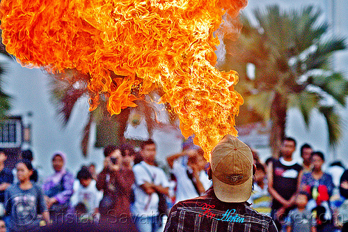 firebreather street performer (jakarta), crowd, eid ul-fitr, fatahillah square, fire breather, fire breathing, fire performer, jakarta, palm trees, spectators, spitting fire, street performers, taman fatahillah