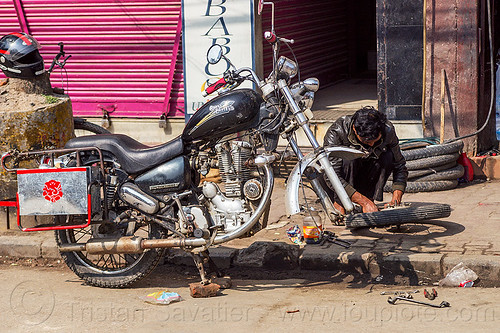 fixing puncture - royal enfield bullet motorbike - kathmandu (nepal), fixing, flat tire, man, mechanic, motorcycle touring, puncture, repairing, royal enfield bullet, thunderbird