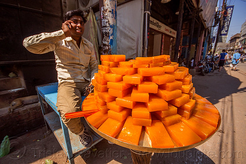 fruit jam street vendor (india), man, orange color, plate, selling, stacked, street food, street seller, varanasi, vendor
