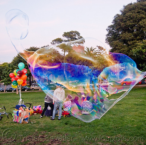 giant soap bubble with weird shape, balloons, big bubble, giant bubble, iridescent, lawn, park, soap bubbles