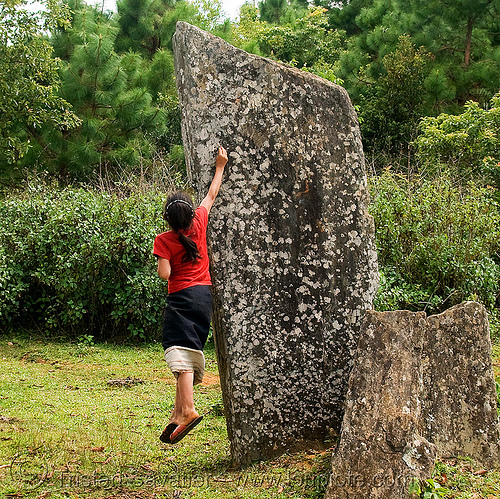 girl catching cicada on menhir (laos), archaeology, child, hintang archaeological park, hintang houamuang, kid, megaliths, memorial stones, menhirs, monoliths, san kong phanh, standing stones