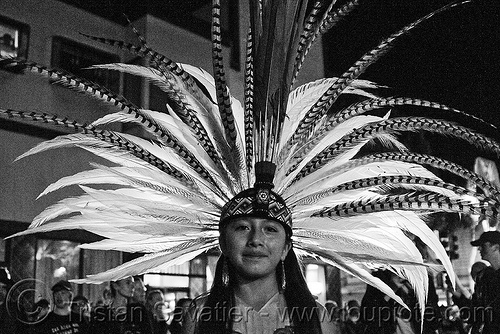 girl in aztec dancer traditional costume - feather headdress - dia de los muertos - halloween (san francisco), aztec costume, backlight, day of the dead, dia de los muertos, face painting, facepaint, feather headdress, feather headwear, feathers, halloween, makeup, night, woman