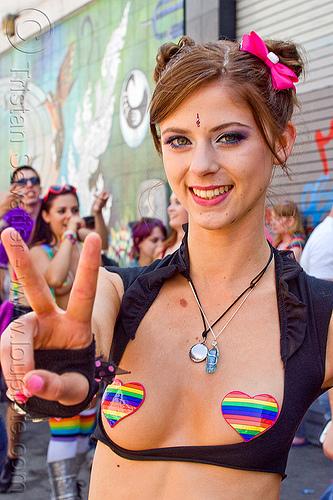 girl with rainbow color pasties, bindis, brianna, crystal necklace, gay pride festival, hair bow, heart pasties, party fashion, peace sign, rainbow colors, rainbow pasties, rave fashion, v sign, victory sign, woman