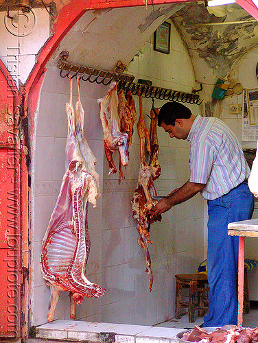 goat carcasses in meat shop, butcher, carcasses, chevon, cutting, goat meat, halal meat, hanging, knife, kurdistan, man, mardin, meat market, meat shop, mutton, raw meat, worker
