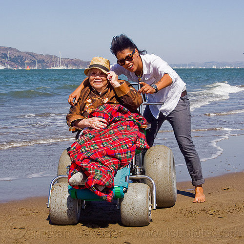 grandma on beach wheelchair with granddaughter, beach wheelchair, blanket, chinese woman, crissy field beach, family, grandma, grandmother, jenn, ocean, old woman, sand, sea, senior, straw hat, women