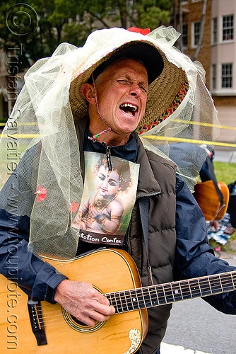 hare krishna singing and playing guitar, bay to breakers, footrace, guitar, hare krishna, hat, lace, man, meditation center, singing, street party