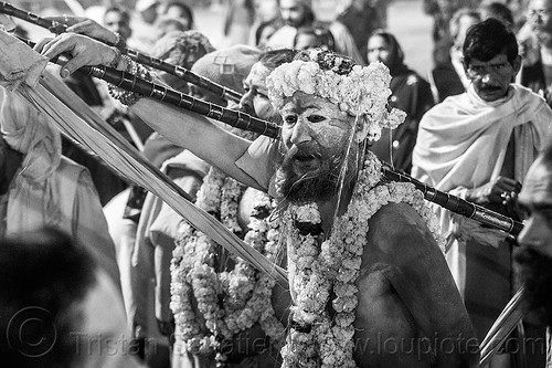 hindu devotees wearing strings of marigold flowers - kumbh mela 2013 (india), crowd, dawn, flower necklaces, hindu pilgrimage, hinduism, holy ash, kumbh mela, marigold flowers, men, naga babas, naga sadhus, night, poles, sacred ash, sadhu, staves, triveni sangam, vasant panchami snan, vibhuti, walking