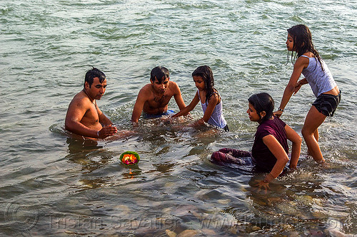 hindu family bathing in ganges river (india), bathing pilgrims, burning, children, floating, ganga, ganges river, ghats, hinduism, holy bath, holy dip, indian women, kids, little girls, men, nadi bath, offering, rishikesh, river bathing, triveni ghat, wading