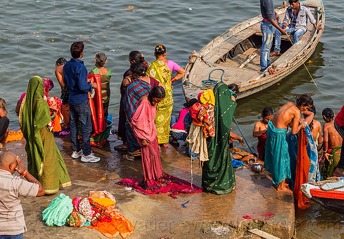 hindu women bathing in the ganges river in varanasi (india), bathing pilgrims, ganga, ganges river, ghats, holy bath, holy dip, indian women, nadi bath, river bathing, river boat, sarees, saris, varanasi
